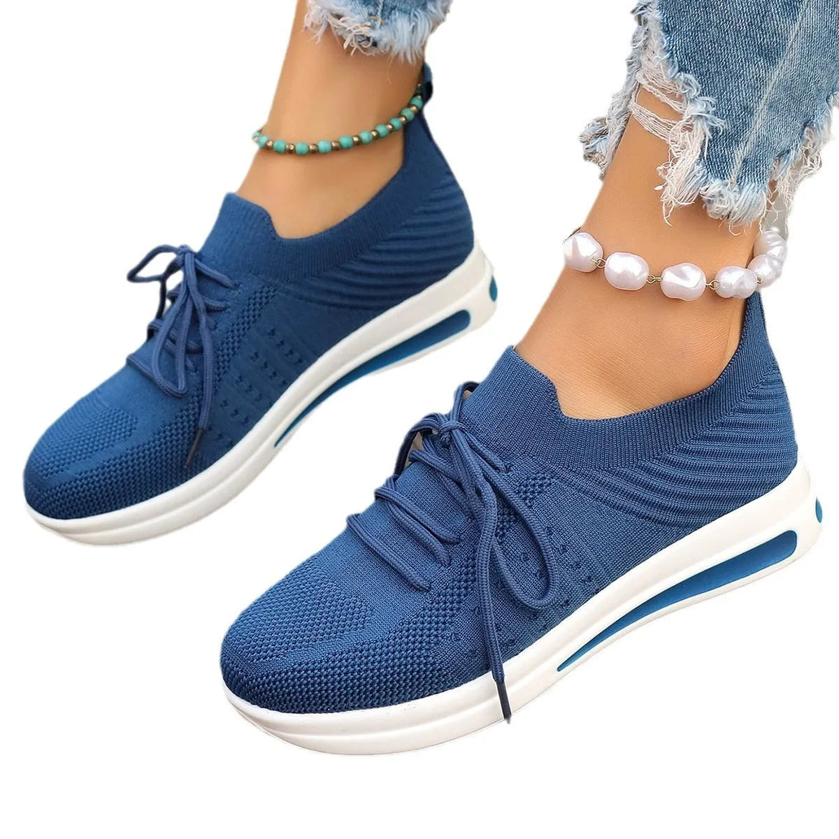 Women's red fly-knit casual sneakers with round toe and lace-up front.