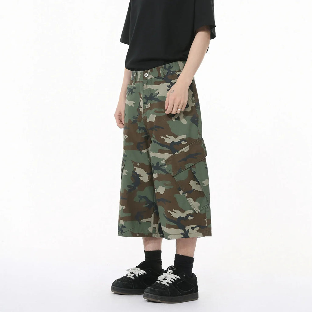 Men's camouflage coloured wide-leg cotton cargo trousers with large patch pockets and side stitching.
