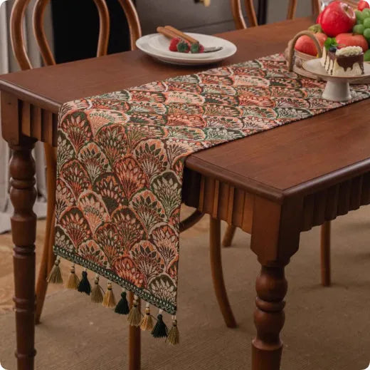 Country European retro style table flag with long handwoven tassels draped over a wooden sideboard.