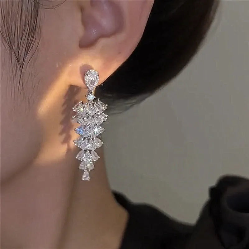 Silver pagoda coloured copper Christmas tree drop earrings with sparkling zircon details and stud fastening.