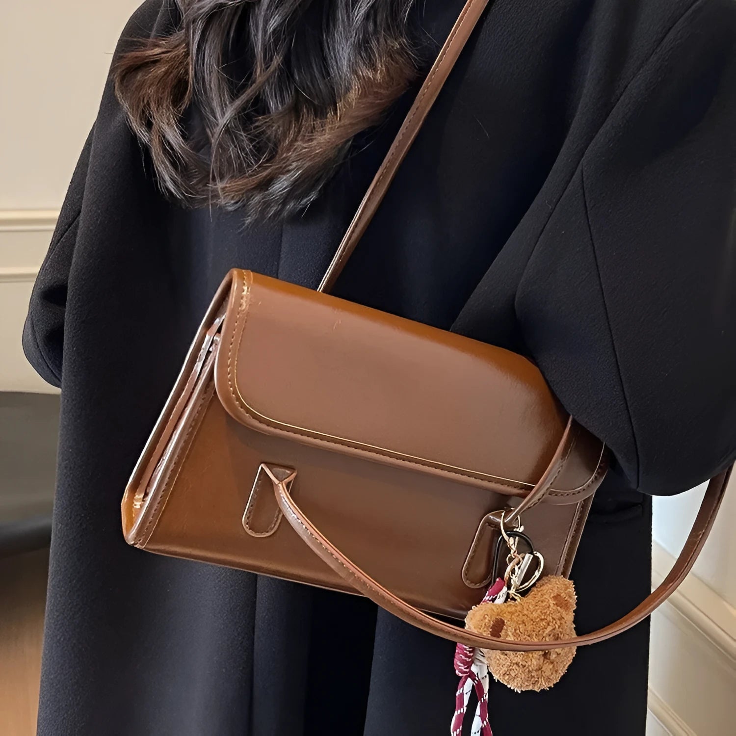 Brown women's Maillard-style PU leather shoulder bag with a double strap and a removable pendant accessory.