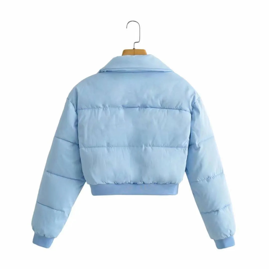 Women's loose blue polyester casual jacket with long sleeves on a hanger.