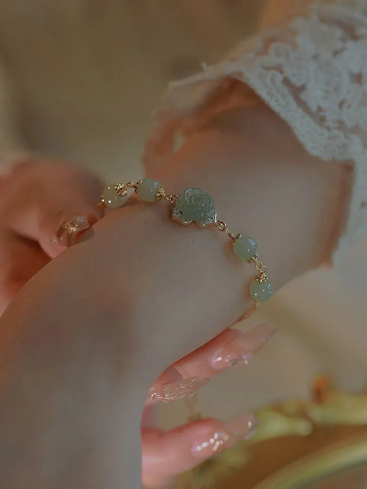 Handcrafted women's bracelet with Hetian Jade rose flower design and 14K gold gilded accents