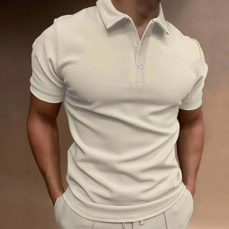 Man wearing a loose fit grey cotton blend T-shirt with a button-down front and short sleeves.
