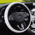 Black elastic steering wheel cover with corrugated texture, stretched to show fit on a 37-38cm wheel.