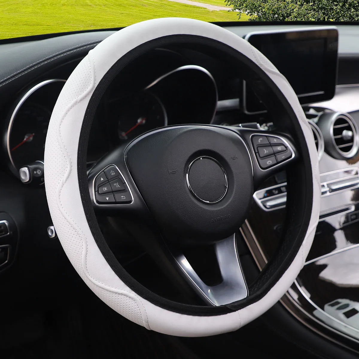 Black elastic steering wheel cover with corrugated texture, stretched to show fit on a 37-38cm wheel.