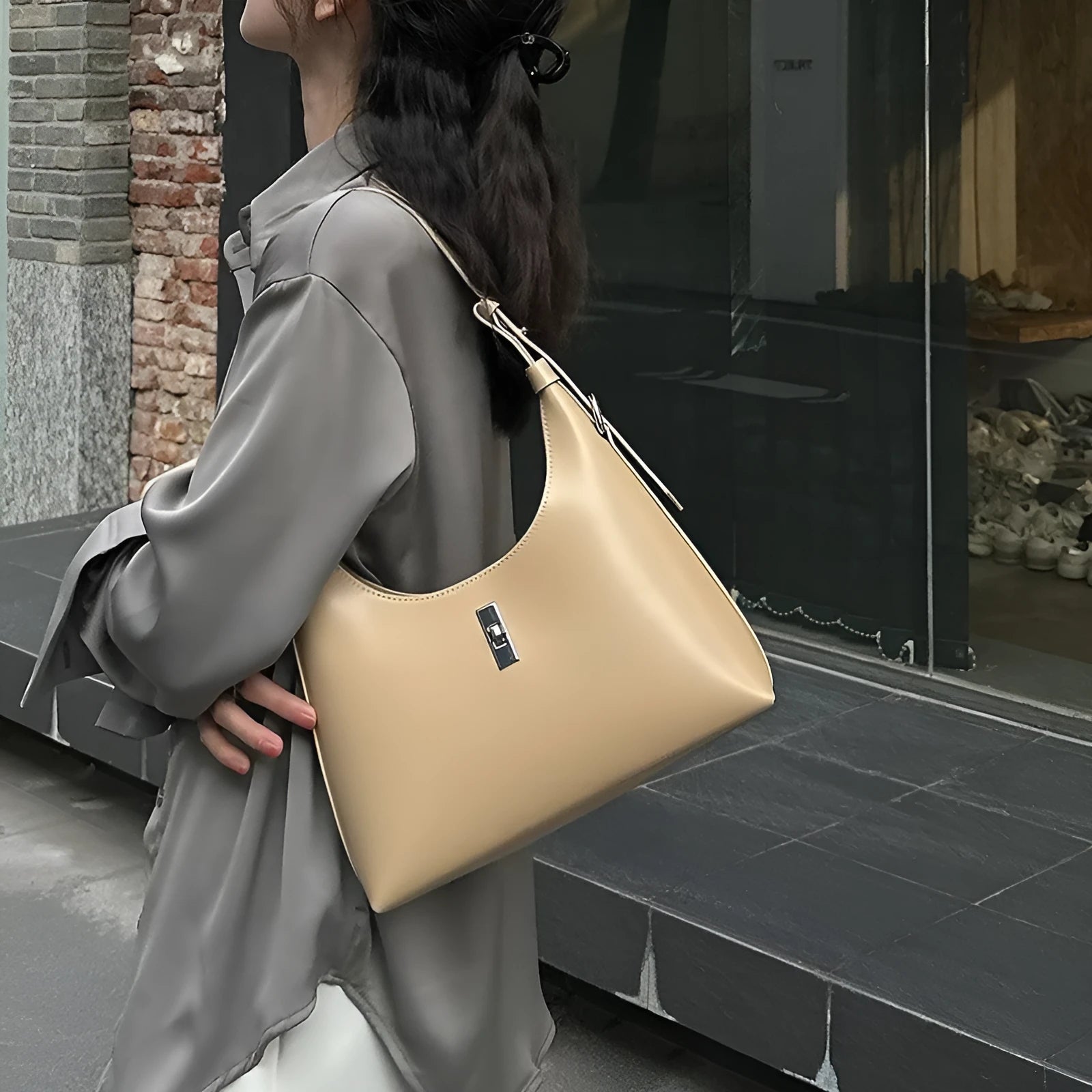 Genuine leather dumpling-shaped crossbody bag in apricot colour with an outer sandwich pocket