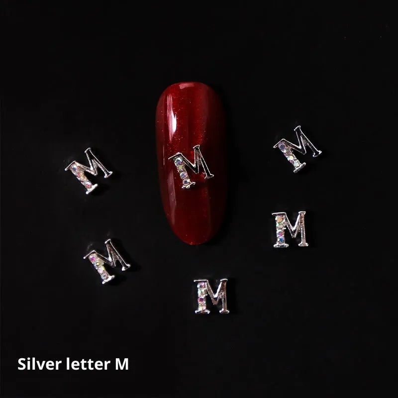 Gold alloy letter A nail ornament charm with crystal detail on a square chain base