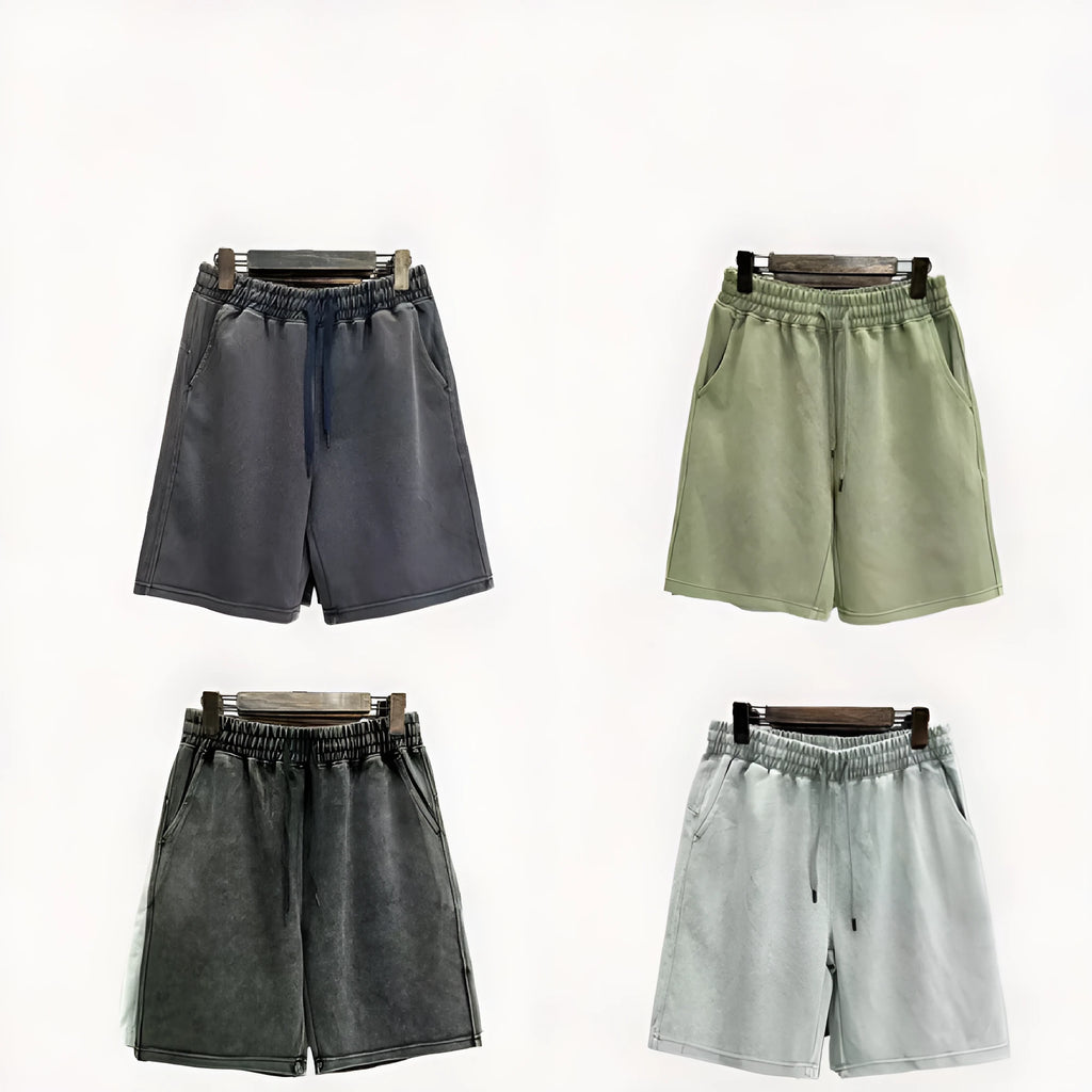 Men's solid colour cotton shorts with distressed detailing on the leg, shown in a loose, straight-leg fit.