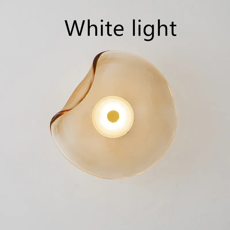 Round glass bedside wall lamp in cognac, light purple, or smoky grey colour.