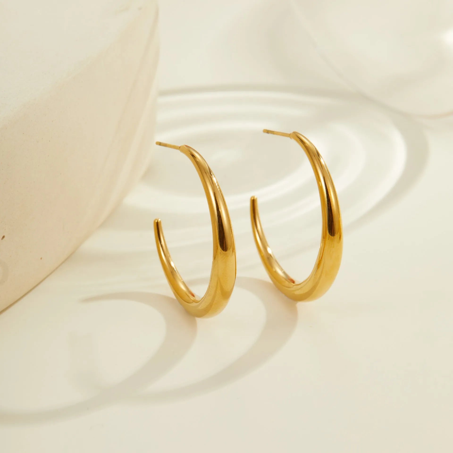 Geometric round titanium steel hoop earrings in gold and stainless steel finishes, small and large sizes