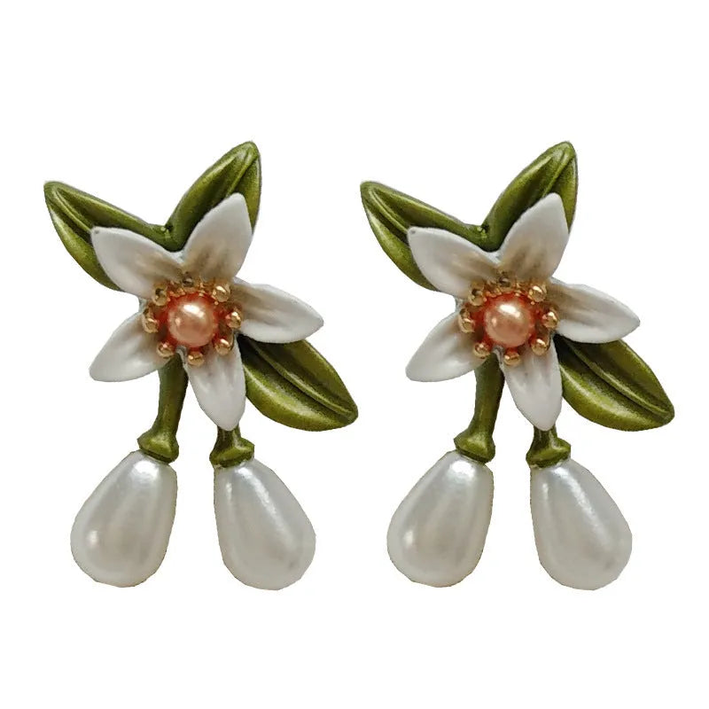 Women's sterling silver needle camellia flower earrings set with stud and clip options