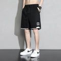Boys cotton shorts in black, shown in a casual setting for summer.