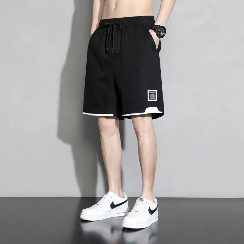 Boys cotton shorts in black, shown in a casual setting for summer.
