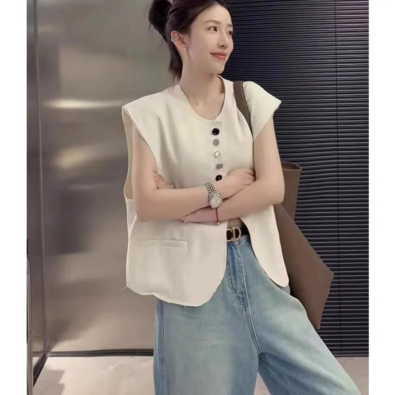 Women's loose fit polyester vest in milky white, featuring a short length and a front pocket.