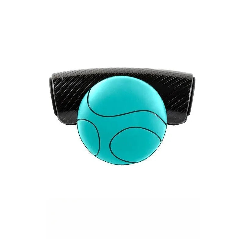 Black silicone steering wheel assist ball with metal bearing mounted on car steering wheel