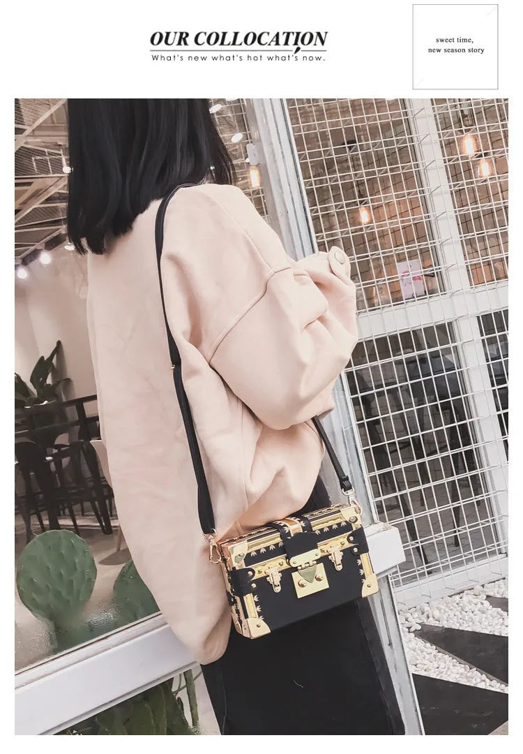 Women's hard PU shoulder bag with flap closure and crossbody strap in black colour with rivet decoration