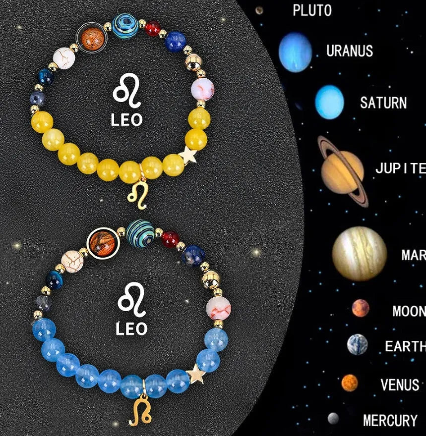 Two natural stone beaded bracelets with zodiac sign charms on a wooden surface