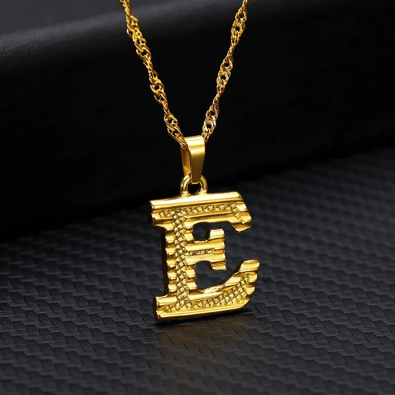Gold-plated alloy initial pendant necklace with 42cm chain on white background