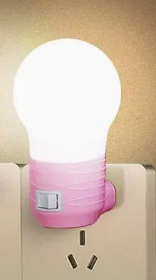 Compact round plug-in bedside lamp in white, blue, or pink for night feeding.