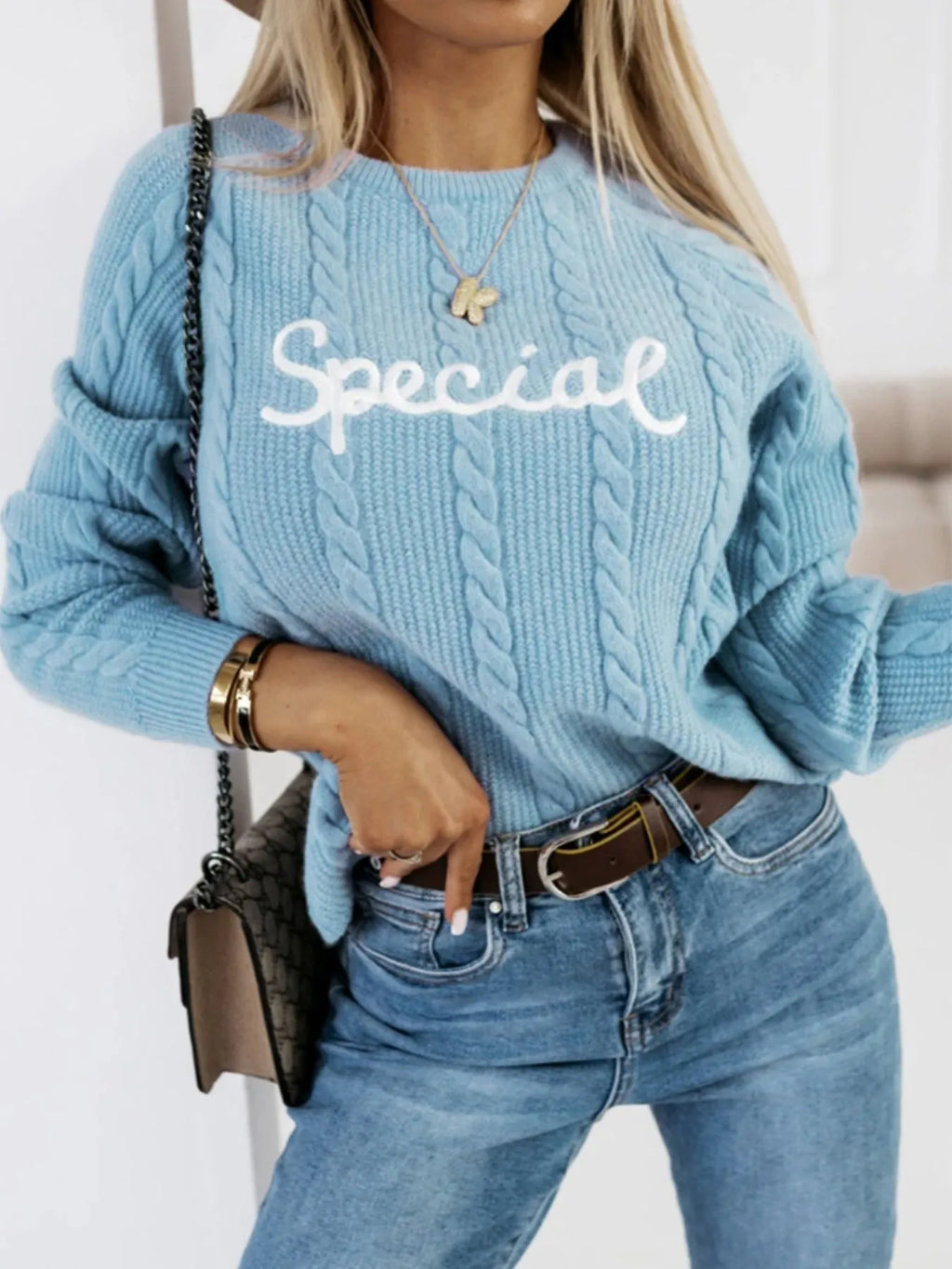 Blue pullover sweater with embroidered letter pattern and crew neck design