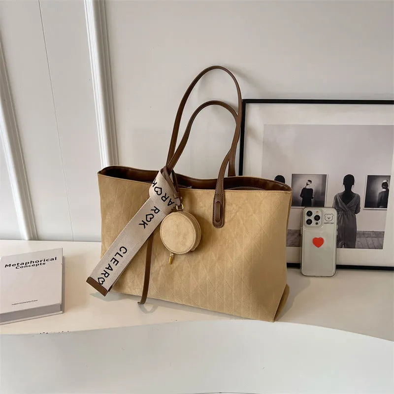 Large casual tote bag with shoulder strap in horizontal square shape with zippered internal compartment