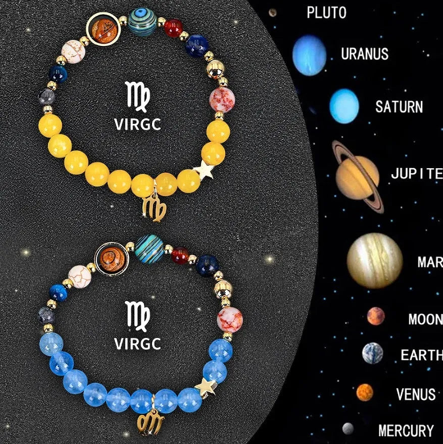 Two natural stone beaded bracelets with zodiac sign charms on a wooden surface