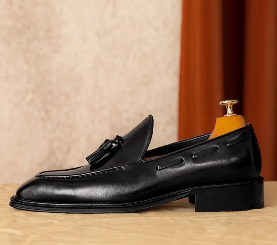 Men's black and brown genuine leather slip-on loafers with a polished finish and rubber sole.