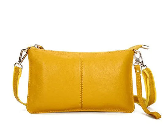 Structured cowhide lady slant bag in apricot colour with hand strap and shoulder strap, showing slim profile.