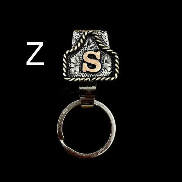 Handmade metal keychain with a cow tag charm in one of 26 available colour options.