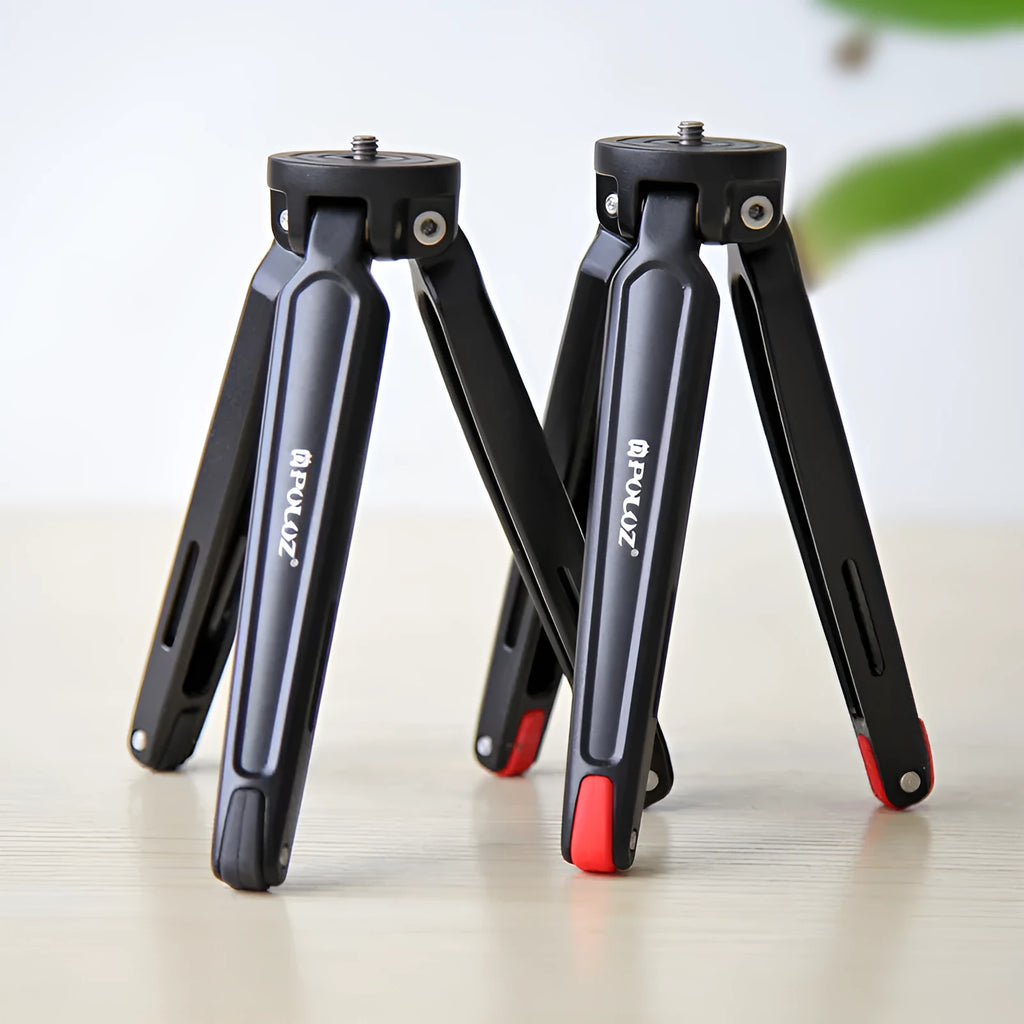 Metal mini tripod with non-slip rubber feet, 15cm max height, black, on uneven outdoor surface