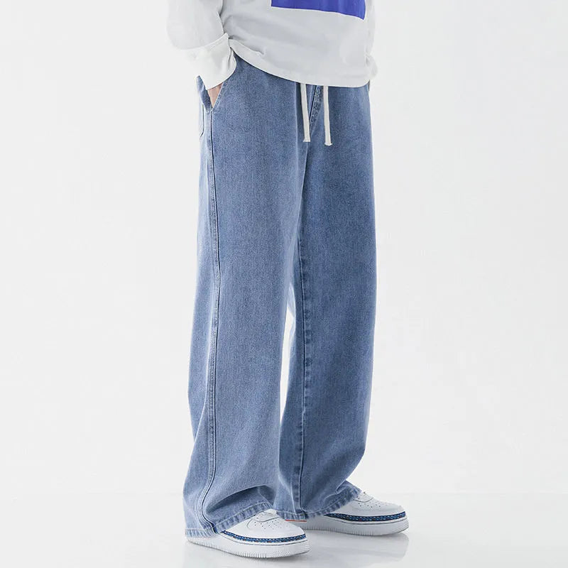 Mens fashion casual loose straight cotton denim jeans in retro light blue colour, full-length view