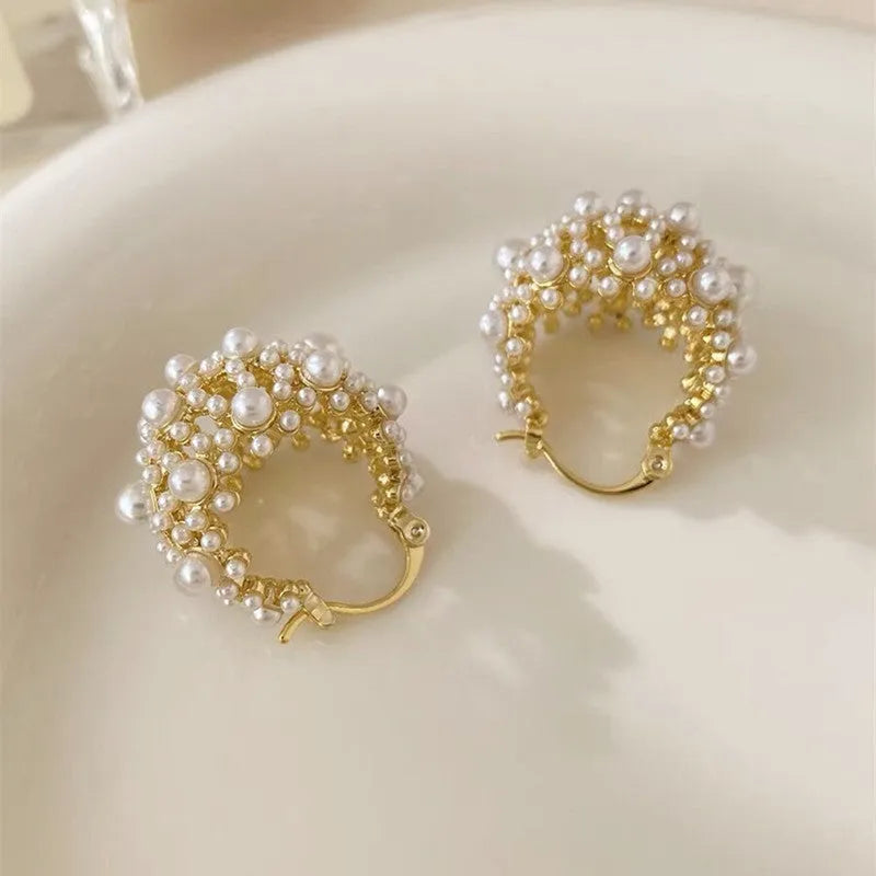 Gold floral basket-shaped women's earrings made from small rice beads with pearl inlay on copper.