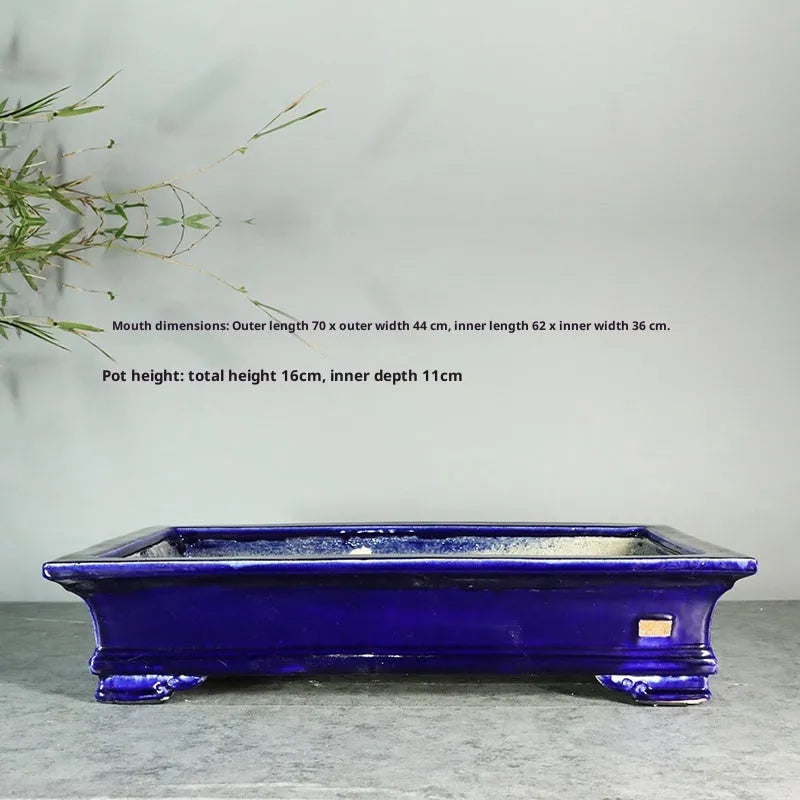 White cracked ceramic bonsai flowerpot with bamboo plant, manual purple sand craft