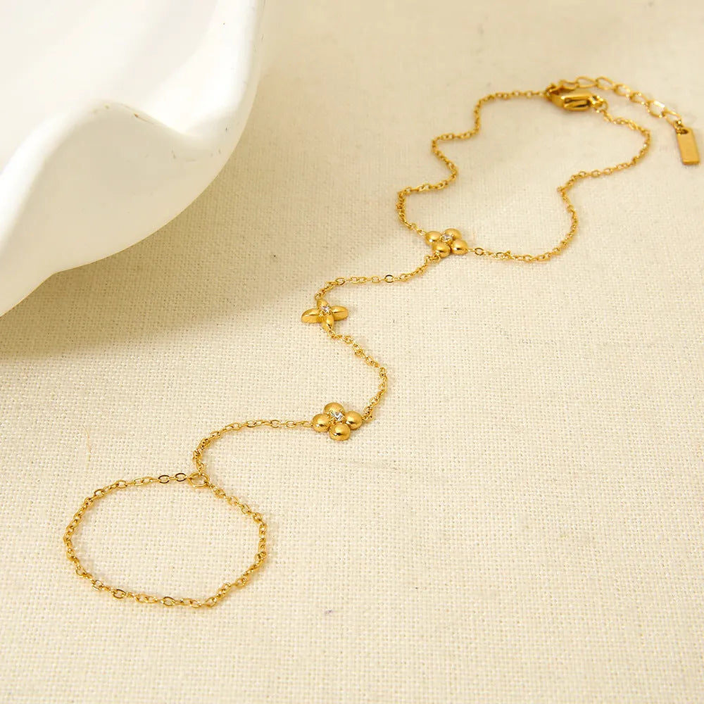 Gold stainless steel women's bracelet with geometric flower and eight-pointed stars design
