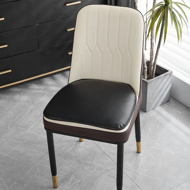 Leather horseshoe-shaped seat cushion in beige colour on a wooden chair, showing non-slip base