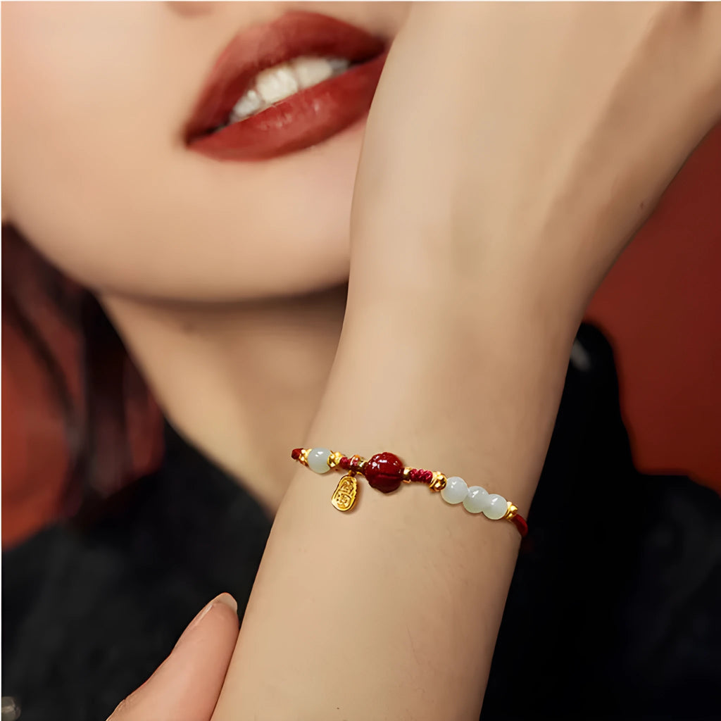 Women's adjustable 925 silver bracelet with Hetian jade and cinnabar red rope design on wrist