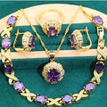 Gold plated jewellery set with blue cubic zirconia stones, showing necklace, earrings, ring, and bracelet.