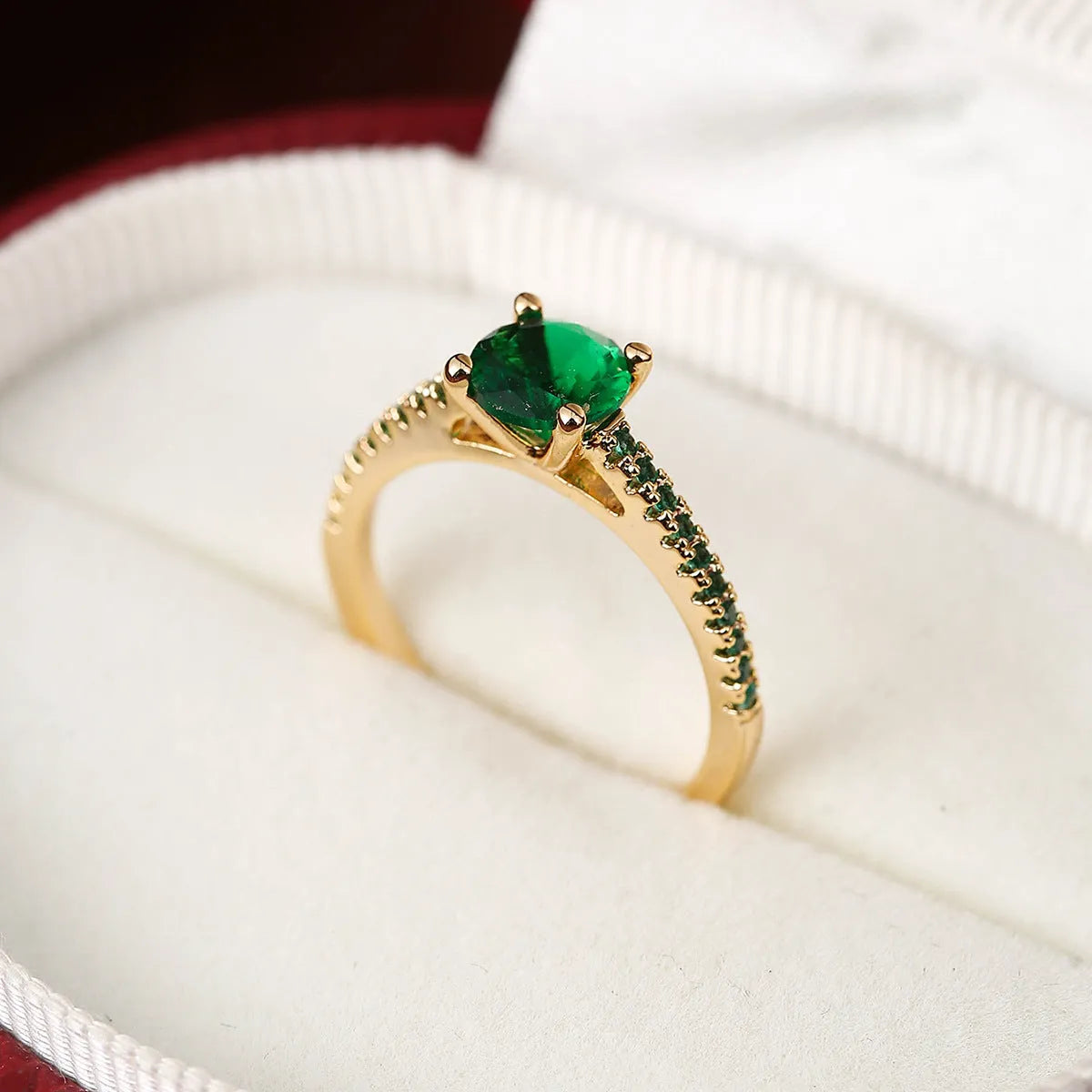 Hexagonal geometric copper ring with zircon electroplating in a gold rose red finish on a hand.