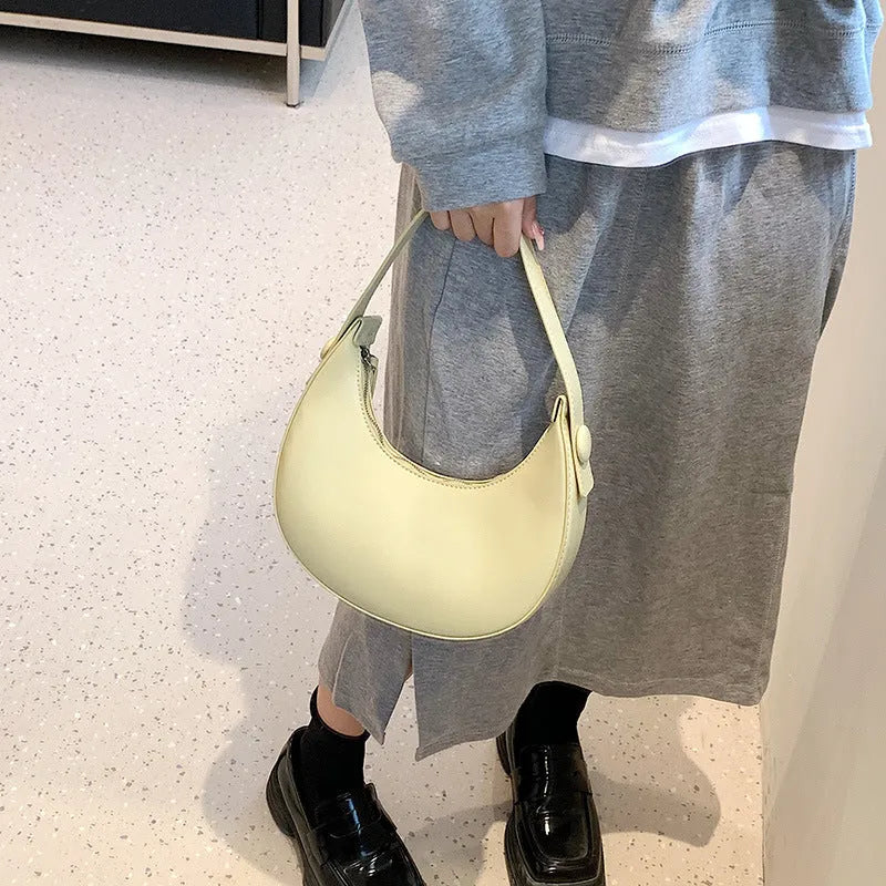 Women's retro-style PU shoulder bag in a dumpling shape, shown in one of four colours: black, cream yellow, brown, or white.