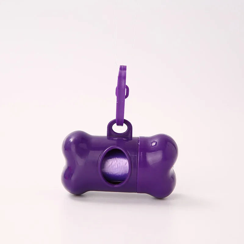Bone-shaped pet garbage bag dispenser in new PP material, 8cm long and 5cm wide, on a table