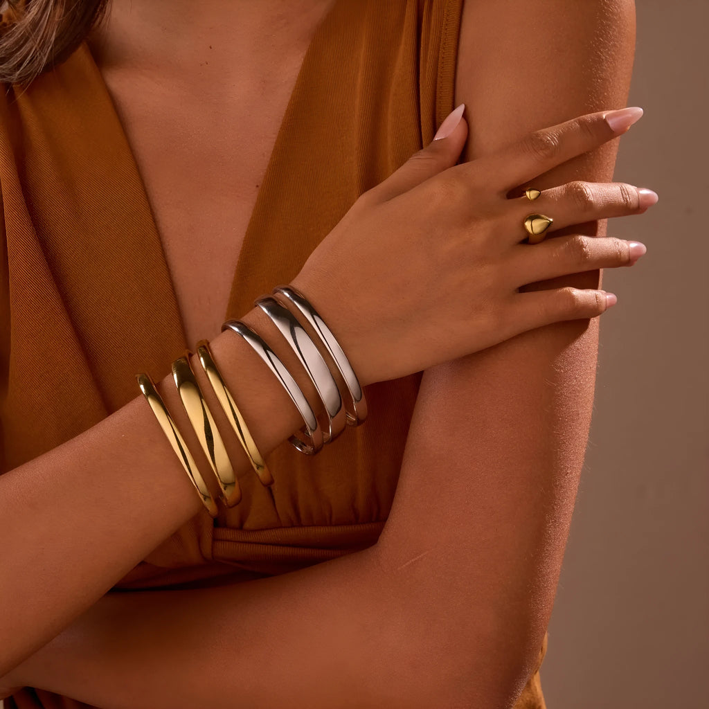 A geometric stainless steel bracelet with a simple opening clasp, shown in a gold electroplated finish.