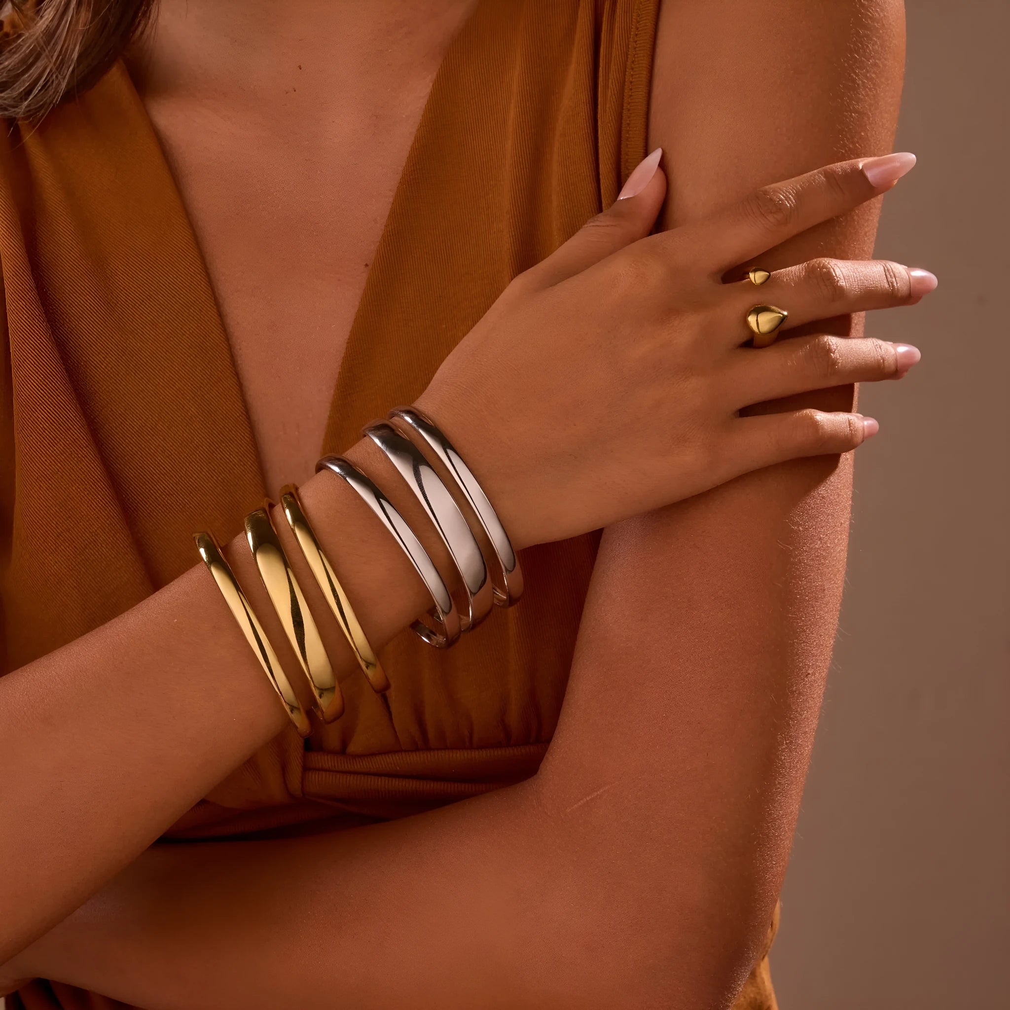 A geometric stainless steel bracelet with a simple opening clasp, shown in a gold electroplated finish.