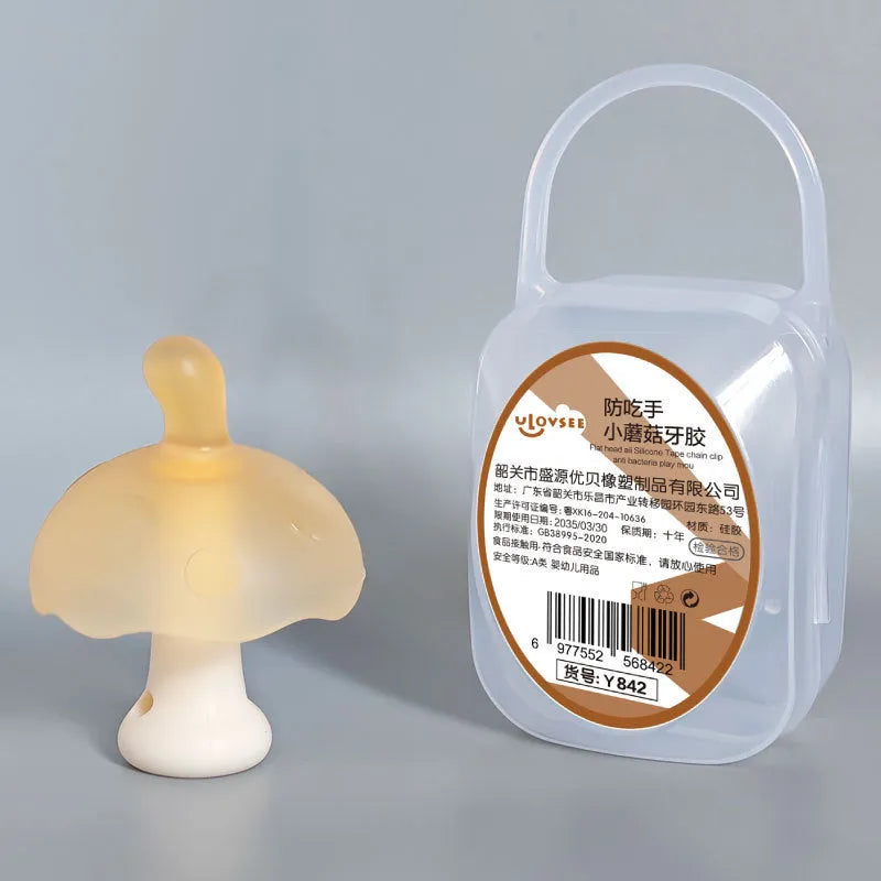 Small mushroom-shaped silicone chewing gum on a chain, in pink or nano colour, inside a transparent box.