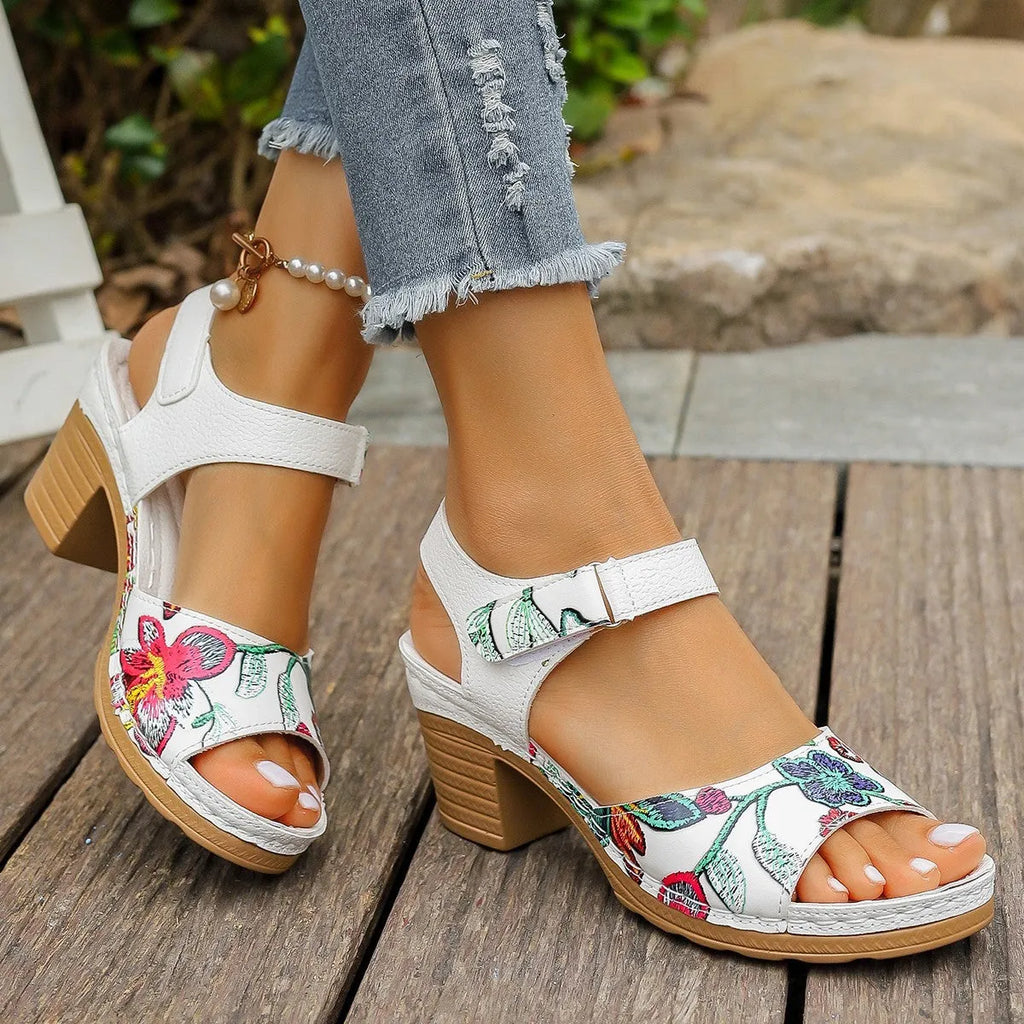 White women's high heel sandals with a visible Velcro strap buckle on a rubber sole.