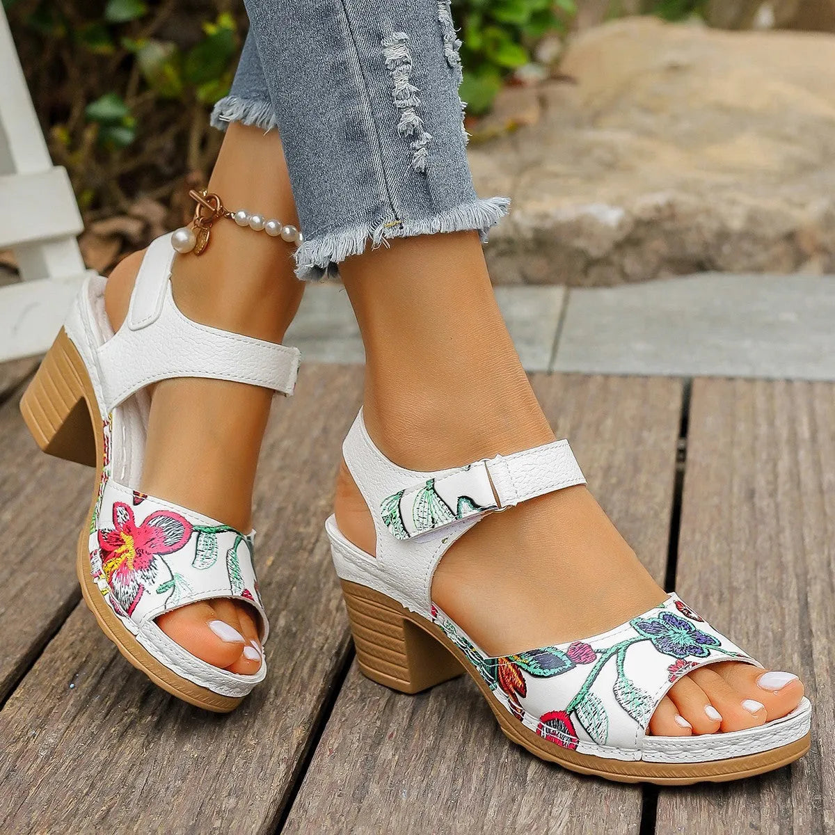 White women's high heel sandals with a visible Velcro strap buckle on a rubber sole.