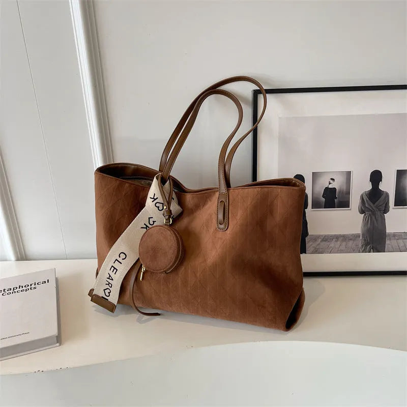 Large casual tote bag with shoulder strap in horizontal square shape with zippered internal compartment
