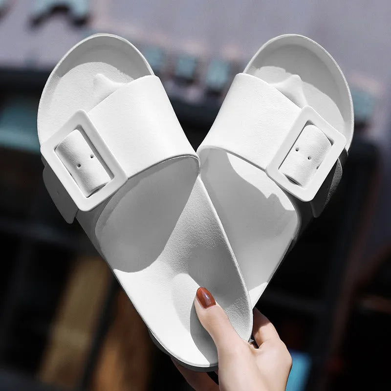 Women's grey blue buckle fastening flip-flop sandals with a soft EVA sole on a white background.