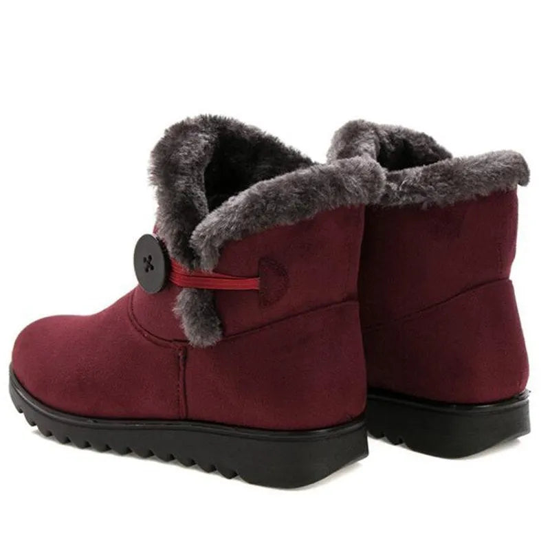 Women's winter flock ankle snow boots with button closure, rubber sole, and low platform in solid colour