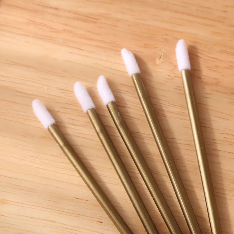Disposable lip brushes with coloured handles and flocked brush heads for lip makeup application
